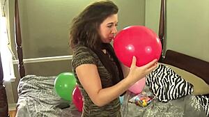 Fifi Foxx blows and pops balloons while enjoying bubblegum